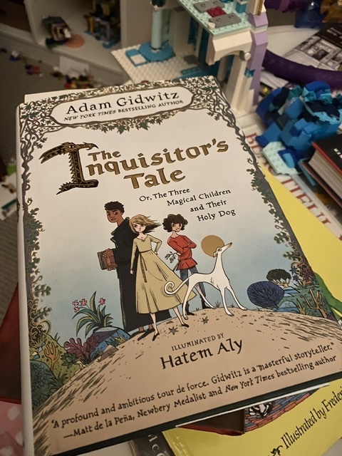 The Inquisitor&rsquo;s Tale on top of a book stack, surrounded by the Lego accretions of Will and Mia&rsquo;s bedroom